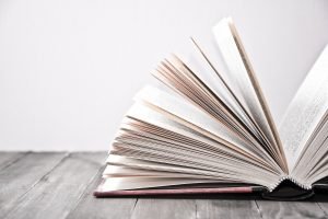 Open book on wooden table. Knowledge and education conceptual image.