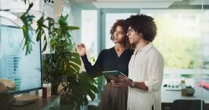 Man,,Woman,And,Tablet,By,Monitor,At,Startup,With,Review,