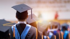 Rear,View,Of,University,Graduates,Wearing,Graduation,Gown,And,Cap