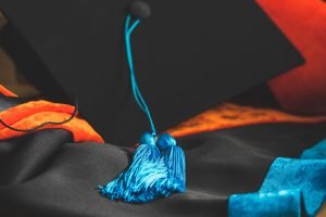 Phd,Graduate,In,Black,Hat,University,Degree,Blue,Tassel,Showing