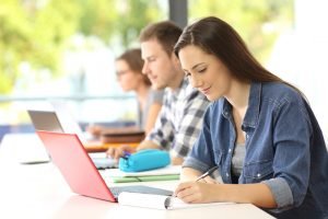 Student,Writing,Notes,In,A,Classroom,With,Other,Classmates,In