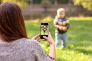 A,Mother,Photographs,Her,Little,Son,In,A,Green,Park