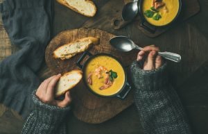 Woman,In,Warm,Grey,Sweater,Eating,Corn,Creamy,Chowder,Soup