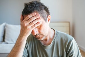 Headshot,Portrait,Of,Sad,And,Depressed,Man,In,Living,Room,